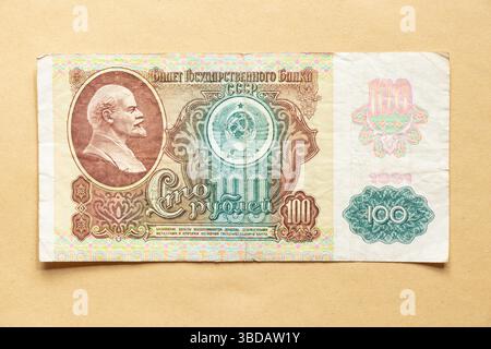 UdSSR-Vintage-Banknote 100 Rubel 1991 mit einem Porträt Lenins und dem Wappen auf handwerklichem Hintergrund, altes Geld Stockfoto