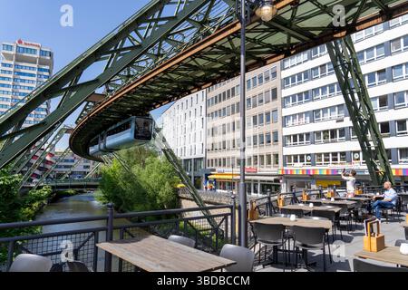 Wuppertaler Schwebebahn entlang der Wupper, an der Haltestelle Hauptbahnhof, Terrasse eines Restaurants auf einer Brücke über den Fluss, Nein Stockfoto
