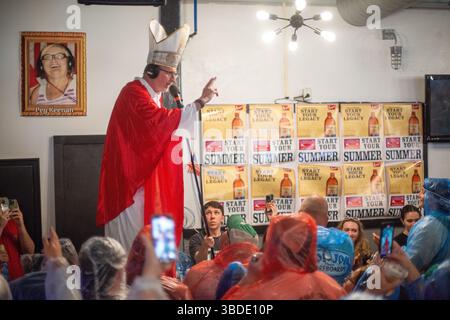 North Wildwood, Usa. Mai 2025. Preston Elliot, gekleidet als Papst, gibt den jährlichen „Segen des Biers“ während der WMMR Preston and Steve Show der Jersey Shore anlässlich des Memorial Day Weekend Freitag, 23. Mai 2025 im Keenan's Irish Pub in North Wildwood, New Jersey. Seit über 20 Jahren sendet die Radioshow aus Philadelphia live im Keenan's, um die Sommersaison zu starten. Dieses Jahr wurde die Veranstaltung von Coors Banquet gesponsert. William Thomas Cain/Alamy Live News Stockfoto