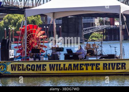 The Big Float, Portland, Oregon – 14. Juli 2018: Eine Band tritt auf einer schwimmenden Bühne auf, um Menschen am Willamette River zu feiern und zu begrüßen. Stockfoto