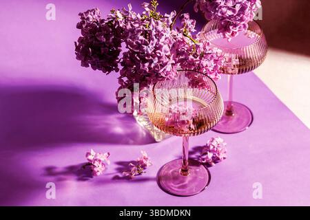 Stillleben mit Fliederblüten und Sektgläsern Stockfoto