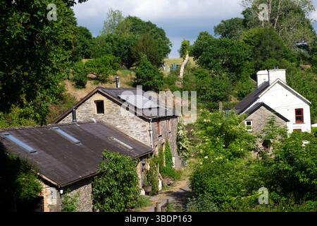 Kleinbäuerliche Gebäude beherbergen ein Haus mit Solarpaneelen auf dem Scheunendach eines umgebauten Gebäudes in Frühlingslandschaft Wales Großbritannien 2025 Großbritannien KATHY DEWITT Stockfoto