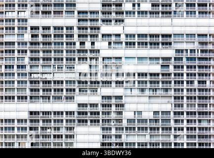 Fassade eines mehrstöckigen Wohnhauses mit Fenstern und Balkonen. Stockfoto