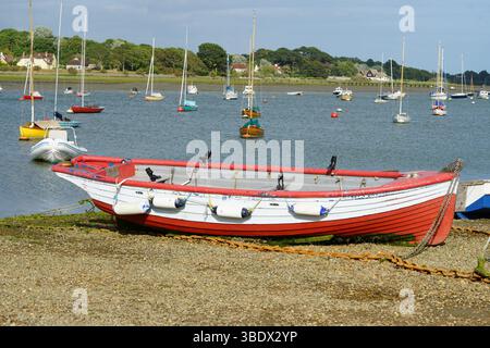 Farbenfrohes Holzboot an einer malerischen Küste mit Booten. Itchenor, Großbritannien Stockfoto