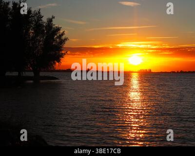 Sommersonnenuntergang über einem friedlichen See im ländlichen Frankreich Stockfoto
