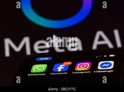 Schwerin, Deutschland. Mai 2025. Die Facebook-, Messenger-, Instagram- und WhatsApp-Apps werden auf einem Smartphone-Display mit einem Monitor mit dem Logo der KI-Anwendung Meta AI im Hintergrund angezeigt. Die Facebook-Gruppe Meta kann nun ihre Systeme der künstlichen Intelligenz in großem Maßstab mit Nutzerdaten aus Deutschland trainieren. Quelle: Jens Büttner/dpa/Alamy Live News Stockfoto