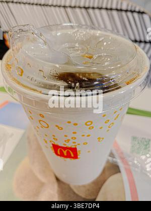Ein halsloser McDonalds-Limonadrink-Becher. Szenen aus der Umgebung von Guangzhou, einem faszinierenden geschäftigen Geschäftsviertel mit Märkten und Stadtvierteln Stockfoto