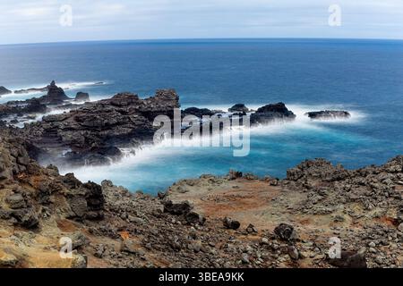 Maui, Hawaii, USA - 9. April 2022: Wellen krachen gegen die felsige Küste Mauis und zeigen die zerklüftete Küste der Insel und die Kraft des Ozeans. Stockfoto