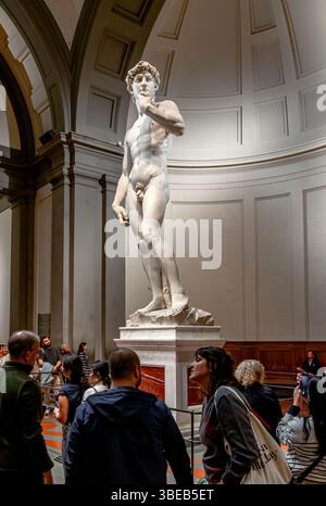 Menschenmassen schauen Michelangelos David, eine Skulptur aus Marmor, die in der Galleria dell’Accademia di Firenze, Florenz, Italien, ausgestellt ist Stockfoto