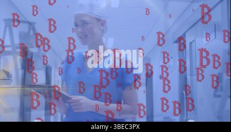 Bild von Bitcoins, die über eine kaukasische Ärztin scheitern Stockfoto