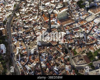 Blick von oben auf die geschwungenen Straßen und Dächer in Ojen und enthüllt das komplizierte Layout dieser andalusischen Stadt. Stockfoto