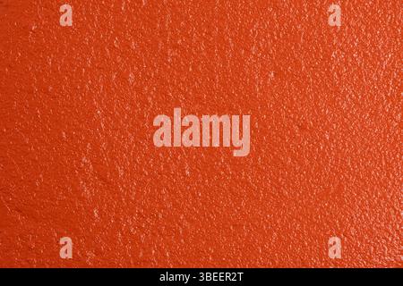 Orangefarbene Wandstruktur. Hintergrund und Textur für Grafikdesign oder Tapeten Stockfoto