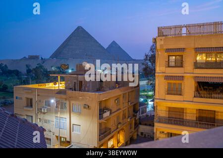 Blick auf die Pyramiden von Gizeh von der Dachterrasse in der Abenddämmerung, Gizeh, Kairo, Ägypten, Afrika Stockfoto
