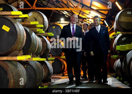 Der erste Minister John Swinney und der japanische Botschafter im Vereinigten Königreich, Hiroshi Suzuki, während eines Besuchs in der Auchentoshan Destillerie in Glasgow. Bilddatum: Freitag, 30. Mai 2025. Stockfoto