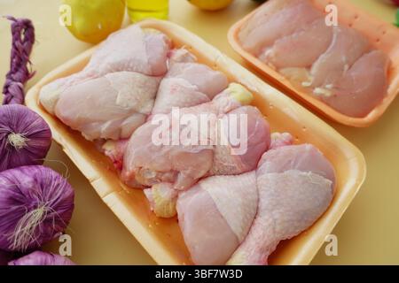 Frische Hähnchenschenkel und Gemüse auf der Küchenzeile Stockfoto