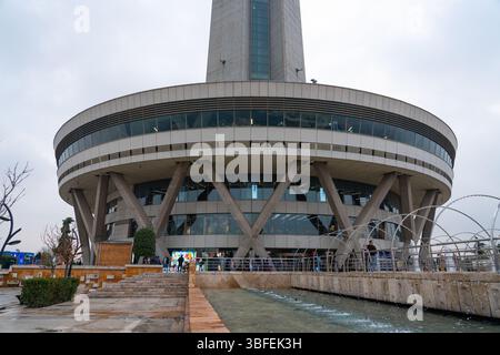 Teheran, Iran - 12. November 2023: Basis des Milad Tower mit Besuchern und Brunnen am öffentlichen platz Stockfoto