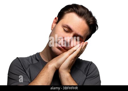 Junger ruhiger Mann schlafendes Porträt isoliert auf weiß Stockfoto