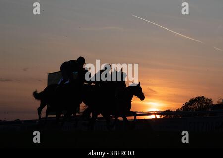 Windsor, Berkshire, Großbritannien. Juni 2025. Jockeys und Rennpferde stehen vor der Skyline, wenn die Sonne auf der Royal Windsor Racecourse in Windsor, Berkshire, während des letzten Rennens des Abends bei Monday Night Racing untergeht. Das Wetter wird sich diese Woche ändern, mit der Regenvorhersage für die nächsten Tage. Quelle: Maureen McLean/Alamy Live News Stockfoto