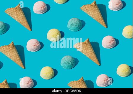 Trendiges farbenfrohes Muster aus Eiskegeln und verschiedenen Eiskugeln auf hellblauem Hintergrund. Minimales Sommerkonzept. Leckere Idee für süßes Essen. Stockfoto