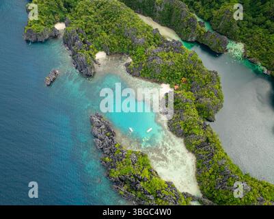 Kajakfahren über klares türkisfarbenes Wasser in der kleinen Lagune auf Miniloc Island. El Nido, Palawan. Philippinen. Stockfoto