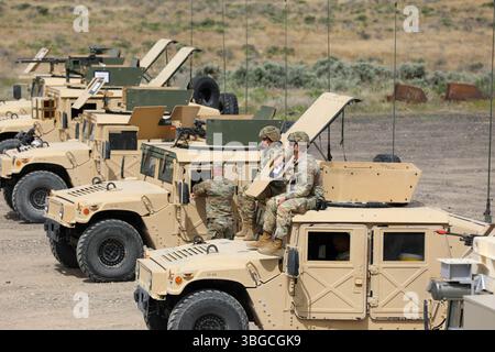 Soldaten der US Army Reserve mit dem 364th Expeditionary Sustainment Command schauen in den unteren Bereich, während andere Kanonenbesatzungen während der Operation Trail Breaker Gunnery im Idaho Combat Training Center am 11. Mai 2025 den Qualifikationsbereich absolvieren. Die Operation Trail Breaker Gunnery ist eine 364. ESC-Trainingsveranstaltung, die aus Geschütztrupps der 96. Nachhaltigkeitsbrigade, der 652. Regionalen Unterstützungsgruppe und der 654. Regionalen Unterstützungsgruppe besteht, die sich auf die Qualifizierung von Waffen durch Besatzungsmitglieder konzentrieren und gleichzeitig qualifizierte Kader entwickeln, um zukünftige Geschützprogramme im gesamten Kommando zu unterstützen. (Foto der US-Armee von Major India Hu Stockfoto