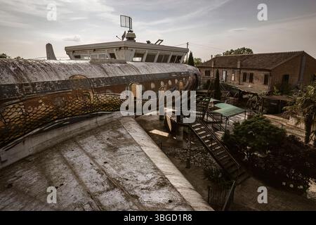 Altes, rostiges Flugzeug, das in ein skurriles Gebäude mit farbenfrohen Graffiti umgewandelt wurde, zeigt urbanen Verfall und Umnutzung Stockfoto