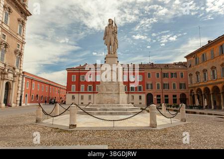 Modena, Italien 1. Januar 2025: Steinstatue des ciro menotti mit einer Flagge auf der piazza grande, modena, italien, umgeben von historischen Gebäuden Stockfoto