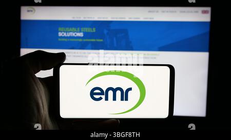 Stuttgart, Deutschland - 03-04-2025: Person mit Handy mit Logo des britischen Unternehmens European Metal Recycling Limited auf dem Bildschirm Stockfoto
