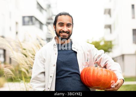Junger Mann mit Kürbis in der Stadt Stockfoto