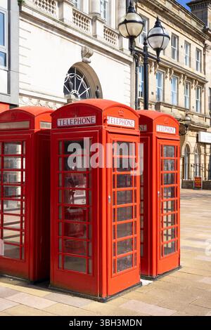 Telefonbox im Stadtzentrum von Stafford 4 traditionelle britische rote Telefondosen auf dem Marktplatz Stafford Staffordshire England Großbritannien GB Europa Stockfoto