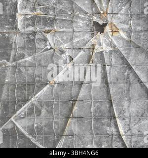 Zersplitterter verstärkter Glashintergrund. Nahaufnahme der Glasscherben Stockfoto