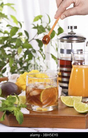 Mango-Eistee mit Limette und Minze hat das perfekte Verhältnis von Saft, Tee und Minze, gesüßt mit Honig und so frisch und köstlich. Bereiten Sie sich diesen Sommer r vor Stockfoto