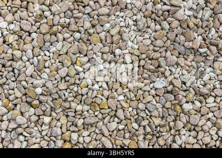 Abstrakter kleiner Steinhintergrund, Texturstein. Stapel pastellfarbener Steine Stockfoto