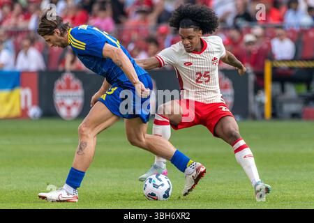 Toronto, Kanada. Juni 2025. Illya Zabarnyi #13 (L) und Jayden Nelson #25 (R) wurden beim Canadian Shield Turnier Spiel zwischen der Ukraine und Kanada im BMO Field gesehen. Endresultate; Kanada 4-2 Ukraine. Quelle: SOPA Images Limited/Alamy Live News Stockfoto