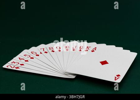 Kompletter Diamantanzug Spielkarten, die auf Pokertisch aufgefächert werden Stockfoto