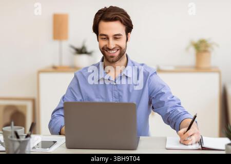 Fröhlicher Geschäftsmann Nimmt Notizen Arbeiten Am Arbeitsplatz Im Büro Stockfoto