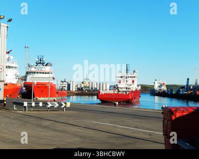 Bright Red Cargo Schiffe legten in einem geschäftigen Hafen an. Aberdeen, Schottland Stockfoto