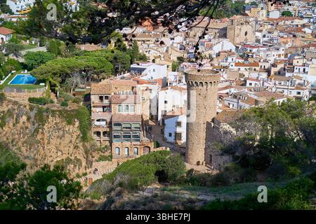 Malerischer Blick auf die Stadt Tossa de Mar, mit einem Steinturm und traditionellen Gebäuden mit Terrakottadächern. Stockfoto