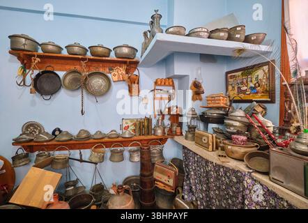 Ein alter Küchenraum, gefüllt mit alten Schüsseln, Metallkochgeschirr und anderen Lebensmitteln. Im Namik Kemal House Museum in Tekirdag, Türkei. Stockfoto