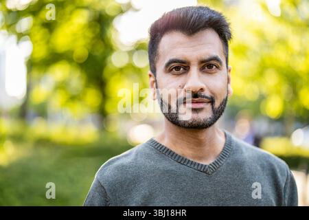 Porträt eines hübschen jungen Mannes mit Bart in der Stadt Stockfoto