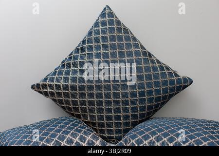 Stilvolles und elegantes Kissen mit geometrischem Muster, das wunderschön auf einem weichen Sofa platziert wird Stockfoto