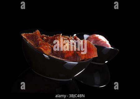 Beef Jerky isoliert auf schwarzem Hintergrund. Trockenes Fleisch Rindfleisch Jerky Stillleben Stockfoto