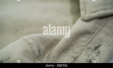Nahaufnahme aus beigefarbenem Stoff mit Naht und Textur Stockfoto