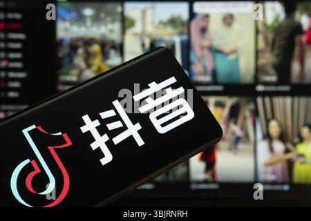 Dhaka, Bangladesch - 18. März 2025: Das Logo des tiktok wird auf einem Smartphone-Bildschirm angezeigt, und die Website tiktok ist auf einem Computerbildschirm sichtbar Stockfoto