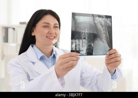 Lächelnder Arzt untersucht Hals-MRT in der Klinik Stockfoto