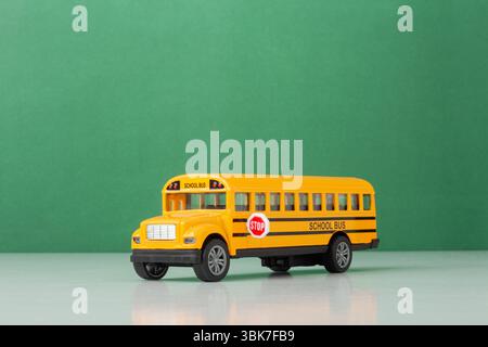 Gelber Schulbus vor dem Hintergrund der grünen Tafel, Back-to-School-Konzept Stockfoto