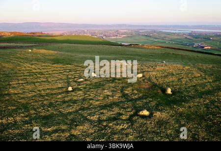 Steinkreis bekannt als Lacra 2 in prähistorischer Landschaft auf Fellside oberhalb von Millom an der irischen Küste, Cumbria. SE anzeigen. Abendlicht Stockfoto