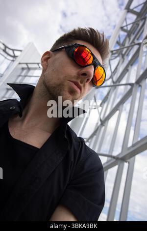 Person mit reflektierender Sonnenbrille in moderner Nahaufnahme Stockfoto