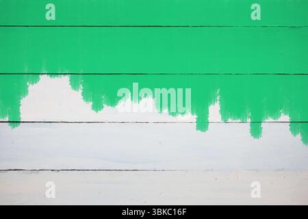 Der Abschnitt der Holzdielen ist in flacher Ausführung mit grünen Tropfen und weißer Farbe zu sehen Stockfoto
