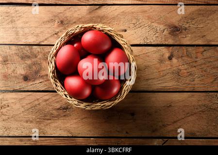 Traditionelle griechische Osterrot gefärbte Eier im Korb auf Holztisch orthodoxes Ostersymbol Stockfoto